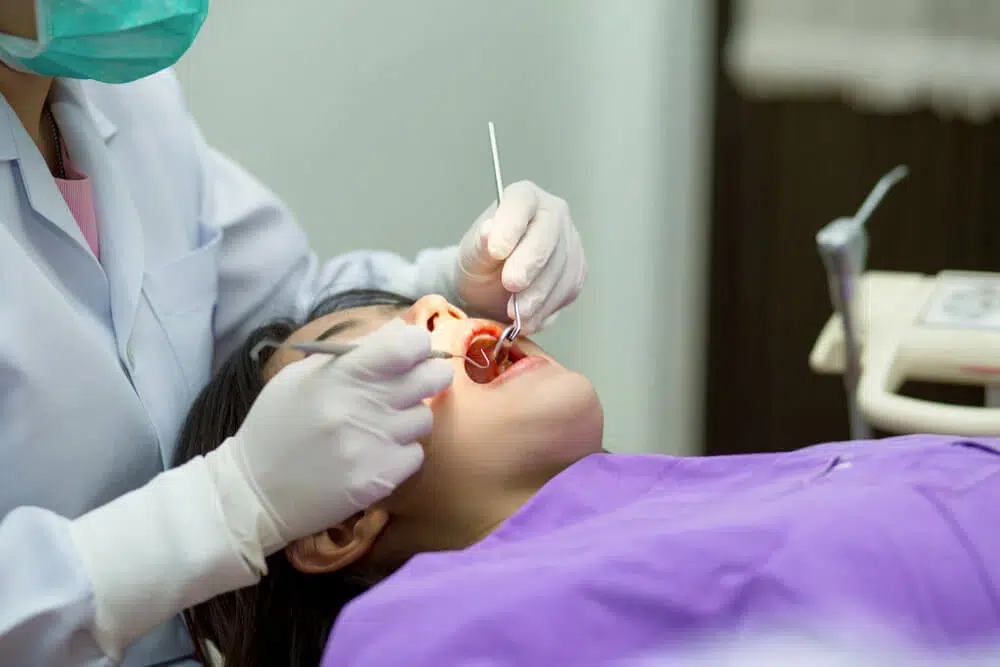 female patient and her dentist preparing for treatment